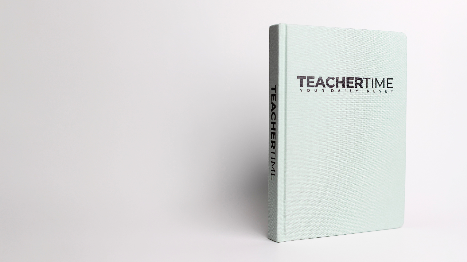 A mint green hardcover book called 'TEACHERTIME Teacher Wellness Jouranl' with the subtitle 'YOUR DAILY RESET' on the front cover and 'TEACHERTIME' spine, photographed on a clean white background