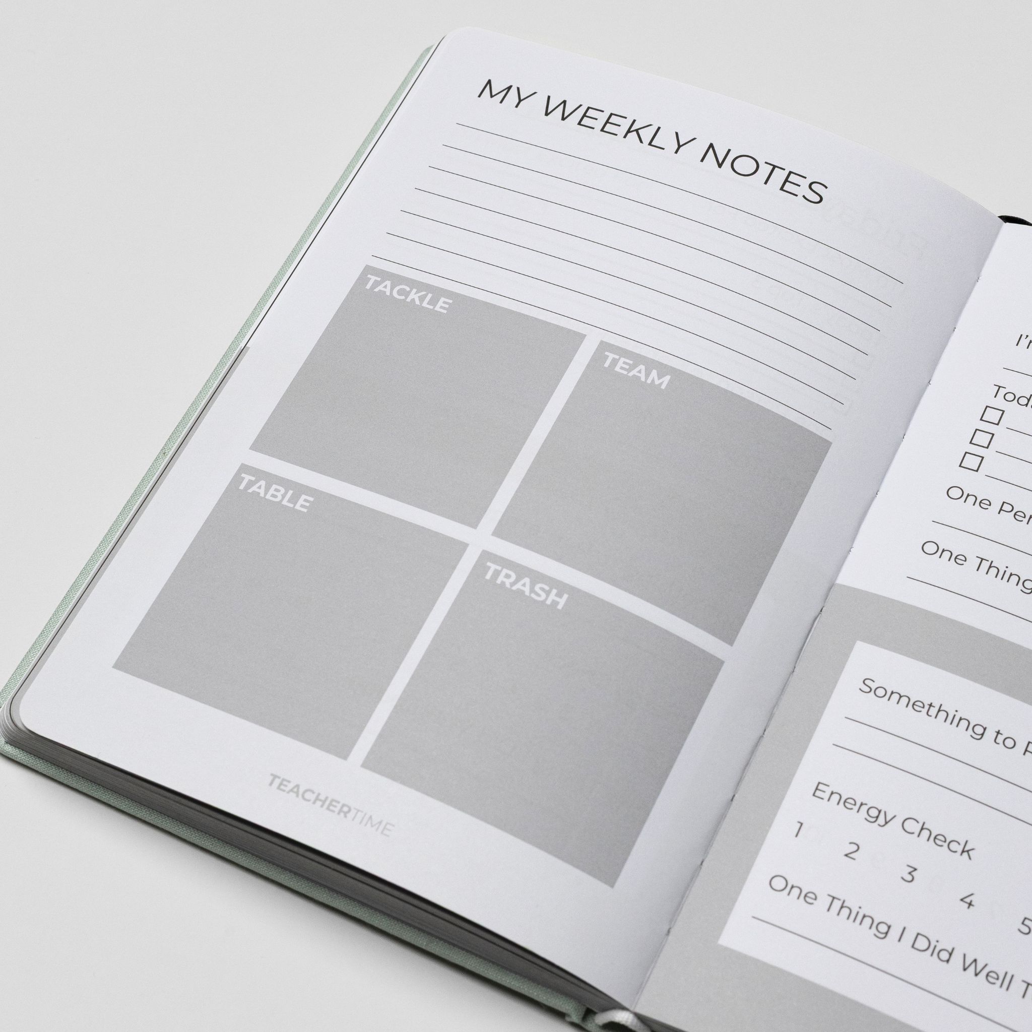 An open notebook or planner showing a weekly notes page with labeled boxes for Tackle, Team, Table, Trash, and Teacher Time, photographed on a clean white background.